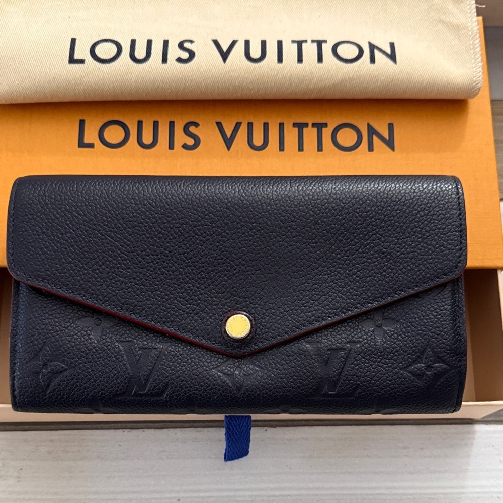 Authentic Pre-owned Louis Vuitton Sarah Empreinte Wallet. NAVY